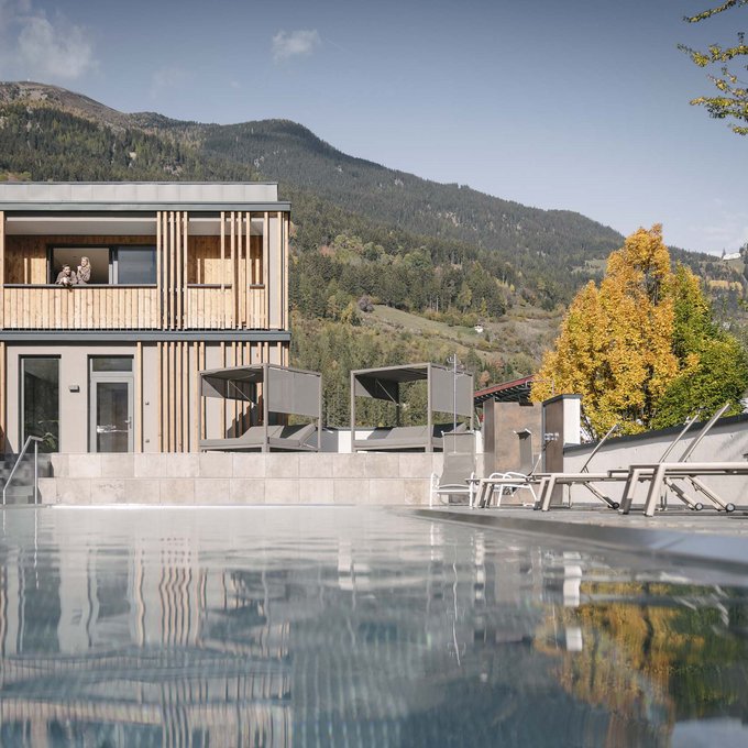 Your accommodation in Prutz Modern wooden building beside a pool with mountains and autumn trees in the background