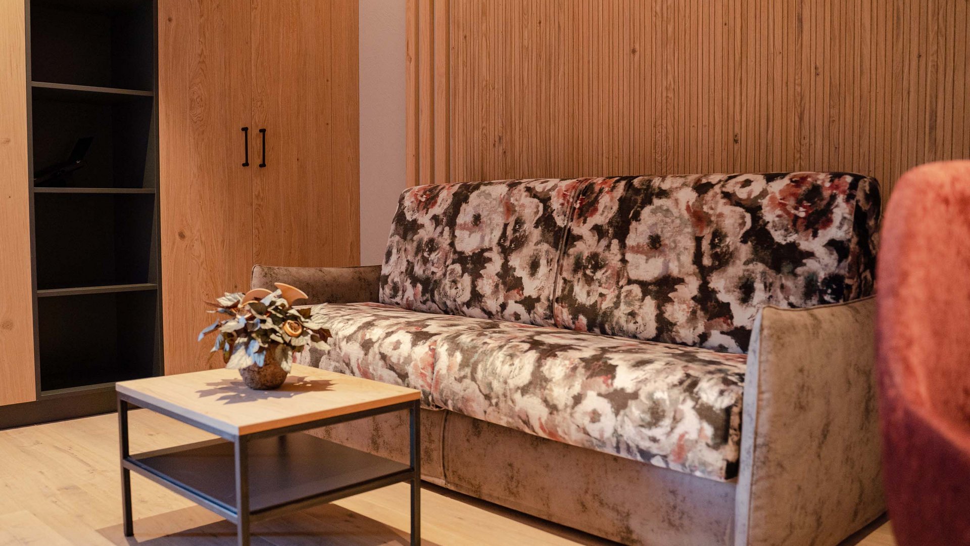 Your Tyrolean Oberland hotel Cozy living room with patterned sofa and small wooden table with decoration