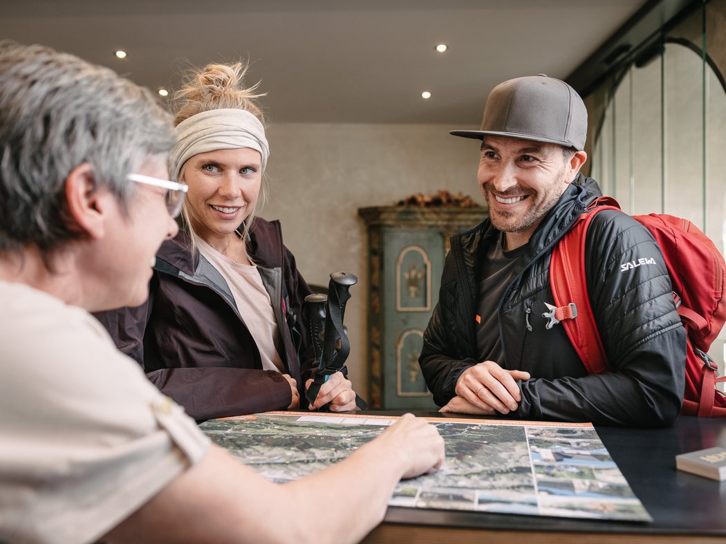 Five excursion destinations around Prutz Two hikers receiving advice at info desk with map