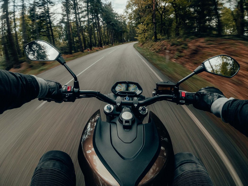 Tip: motorcycle tour Rider's view on a motorcycle on a forested rural road